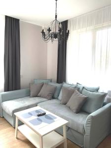 a living room with a couch and a table at Apartamentai centre in Klaipėda