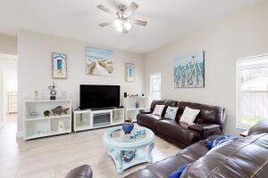 uma sala de estar com um sofá e uma televisão em Happy Beachy Casa em Fort Pierce