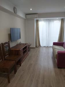 a living room with a couch and a tv at Modern flat at Garbinet with WiFi in Alicante