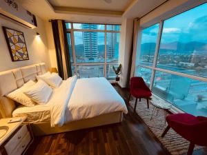 伊斯兰堡High Rise Presidential Suite in Elysium Opp Centaurus的一间带床和大窗户的酒店房间