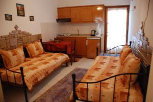 a living room with a couch and a table at ΠΑΝΣΙΟΝ ΑΓΓΕΛΟΣ ΜΑΝΑΡΗ in Ouranoupoli +44 photos
