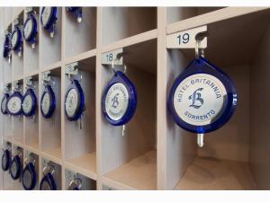 a bunch of blue clocks are on a shelf at Hotel Britannia in Sorrento