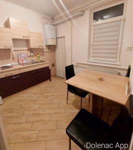 a kitchen with a table and chairs in a room at Studio apartman Dolenac in Zagreb
