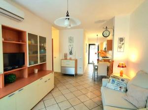 a living room with a couch and a dining room at Mikey Appartamento con Terrazza in La Maddalena