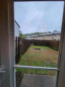a view of a yard through a sliding glass door at Lovely welcoming 3 bedroom house 