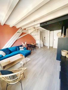 a living room with a blue couch and a table at Tres bel appartement le Concordance in Mulhouse