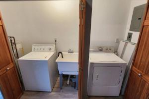 eine kleine Küche mit Spüle und Waschmaschine in der Unterkunft Harbor Haven: Stay, Sail, Dine! 
