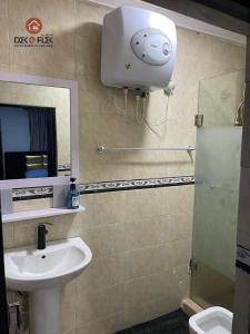 a bathroom with a sink and a mirror and a toilet at Dex & Flex Apartments in Ibadan