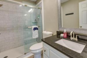 a bathroom with a sink and a toilet and a mirror at Bella Vista Townhome with Deck Near Back 40 Trails! in Bella Vista +21 photos
