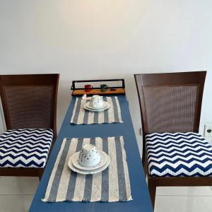 a table with two chairs and a plate on it at Espaço Azul in Curitiba