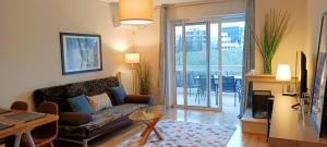 a living room with a couch and a table at Filoxenia House Marousi -private parking- in Athens