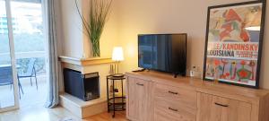 a living room with a television on a wooden dresser at Filoxenia House Marousi -private parking- in Athens