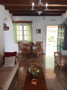 a living room with a couch and a table at Villa Aliki in Ágios Stéfanos