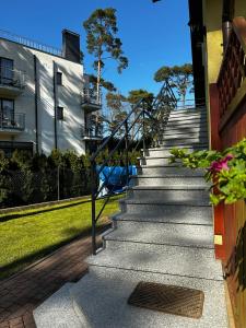 a set of stairs leading up to a building at Dom pod Sosnami in Pobierowo