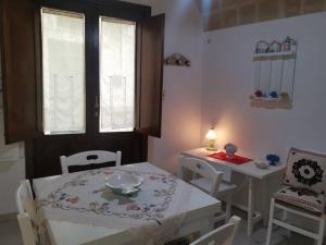 a dining room with a table and a table and chairs at Casa Centro storico Gallipoli in Gallipoli