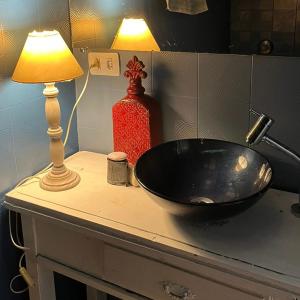 a black sink sitting on a counter next to a lamp at Espaço Azul in Curitiba
