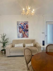 a living room with a couch and a painting on the wall at Casa Roma in Collegno