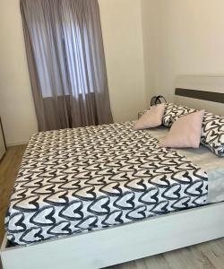 a bed with a black and white comforter on it at Casa Roma in Collegno