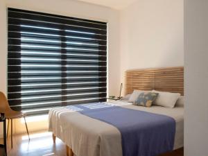 a bedroom with a bed and a large window at Segesta - with panoramic outdoor area and swimming pool in Parzanica