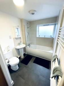 a bathroom with a toilet and a shower and a sink at 1 Bedroom flat in Peterborough City centre in Peterborough