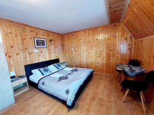 Spanie po Zbóju في كوشتيليسكا: غرفة نوم بسرير ومكتب في غرفة