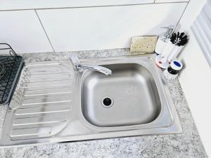 a kitchen sink with a drain in it at Quantum Heights - Studio Apartment in Fourways