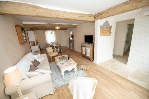 a living room with a white couch and a table at Le clos des voisins in Verneuil