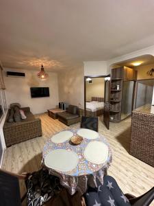 a living room with a table and a couch at Amazing Magnolia in Batumi