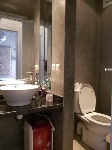 a bathroom with a sink and a toilet and a mirror at Essaouira cosy in Essaouira +23 photos