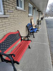 a row of benches lined up against a building at Motel Sainte Catherine in Sainte-Catherine
