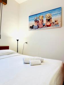 a bedroom with a bed with a painting on the wall at Villa Riviera by the Sea in Lignano Sabbiadoro