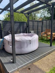 two large beds sitting on a deck under a gazebo at Westgate House - 5 bedroom newly renovated house with hot tub & private parking in Canterbury