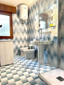 a bathroom with a toilet and a sink and a shower at Villa Riviera by the Sea in Lignano Sabbiadoro