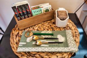 a table topped with a wicker table with scissors and a basket at The Loubird Inn in Escalante