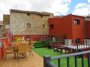 a balcony with a table and chairs and a building at Casa Rural El Pescador 
