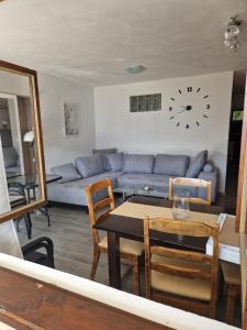 a living room with a couch and a table and a clock at Apartment MMP in Kotor +13 photos