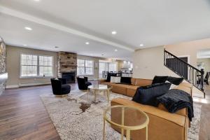 a living room with a couch and a table at Luxe Lrg Pocono House for 18 Hot Tub/Gameroom/Pool in Kunkletown