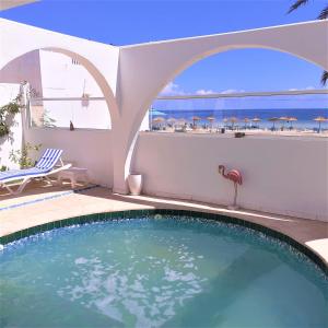 a swimming pool with a view of the ocean at VILLA KIKA ZARZIS, LOCATION CHAMBRES D'HÔTES en TUNISIE in Zarzis