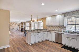 a kitchen with white cabinets and a hard wood floor at Luxe Lrg Pocono House for 18 Hot Tub/Gameroom/Pool in Kunkletown