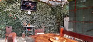 a room with a table and a tv on the wall at Casa Marinela in Baile Felix