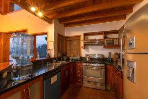 a kitchen with wooden cabinets and a counter top at Balam Ya in Panajachel