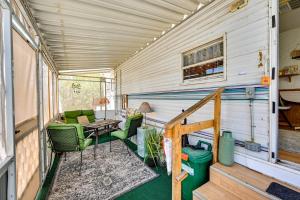 a screened in porch of a tiny house with chairs and a table at Yuma Getaway with Pool Access, 5 Mi to Lutes Casino! in Yuma