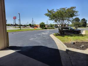 a shadow of a car parked in a parking lot at Budget Inn, Hwy 41 in Barnesville