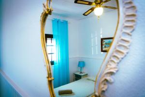 a mirror in a room with a bed and a window at Hostel Blue Lagoon in La Mareta