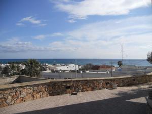 a stone wall with the ocean in the background at B&B Lu Cantoru in Marina di Pescoluse