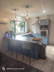 a kitchen with a blue island in the middle of it at Cozy Double Room - WIFI in Hamilton