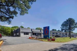 a building with a colgate sign in front of it at Motel 6 North Little Rock, AR-JFK Blvd in North Little Rock