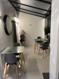 a room with tables and chairs and a mirror at Oxford Studios in Kidlington