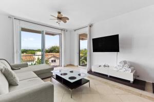 a living room with a couch and a flat screen tv at 4 BR apartment, 8 guests in Cancún