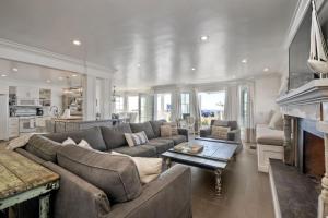 a living room with a couch and a table at Luxury Ocean Views & Steps To The Sand - Tower 36 Lower Condo Unit in Carlsbad
